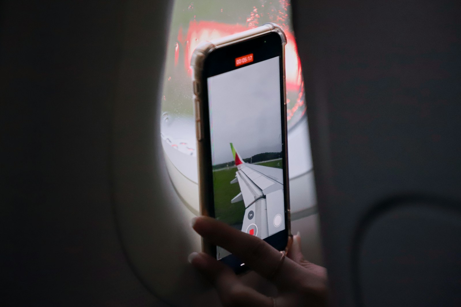 a person taking a picture of an airplane